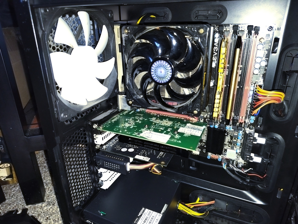 GT 630 installed in computer. Fan controller screwed into rear PCI slot mount parallel with the expansion cards.