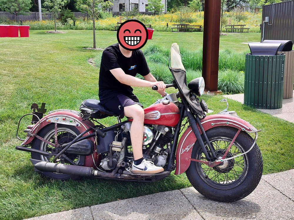 My friend Rex, censored, sitting on a war-time, civilian Harley-Davidson 45 motorcycle.