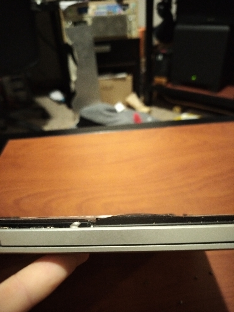 Profile shot of the battery highlighting the swollen cells.