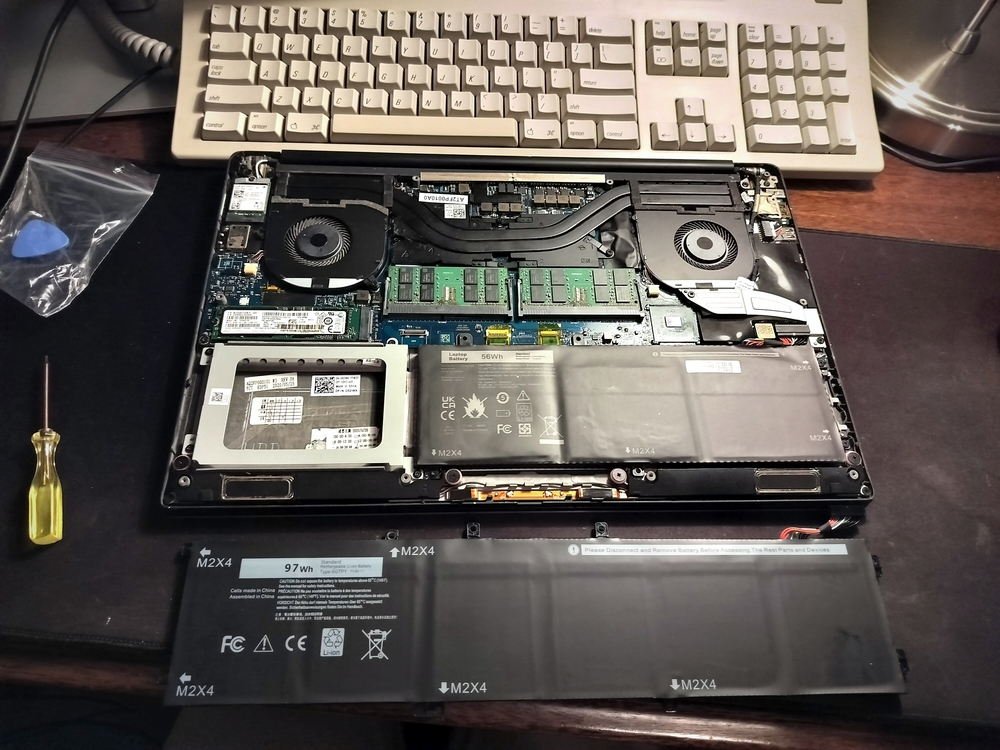 Inside my Dell Precision 5540 with new, larger battery next to machine for comparison.