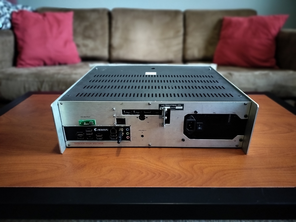 Custom rack chassis rear view highlighting motherboard I/O, power button, graphics card I/O, and power supply.