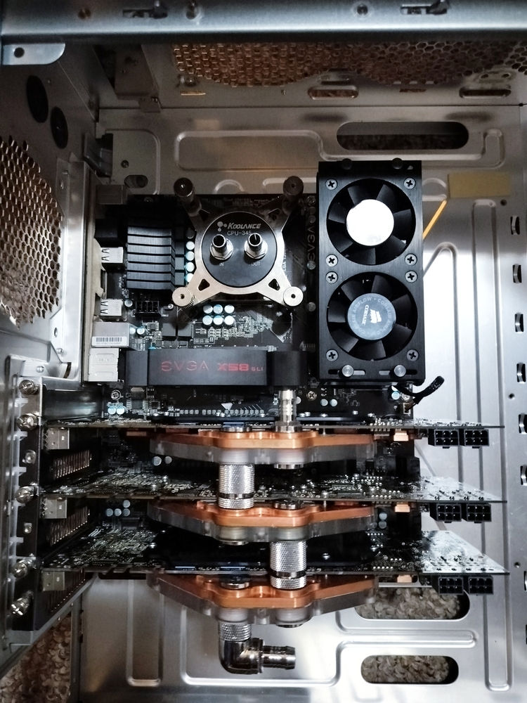 Motherboard and GPU assemblies mounted in empty Cooler Master Cosmos S chassis