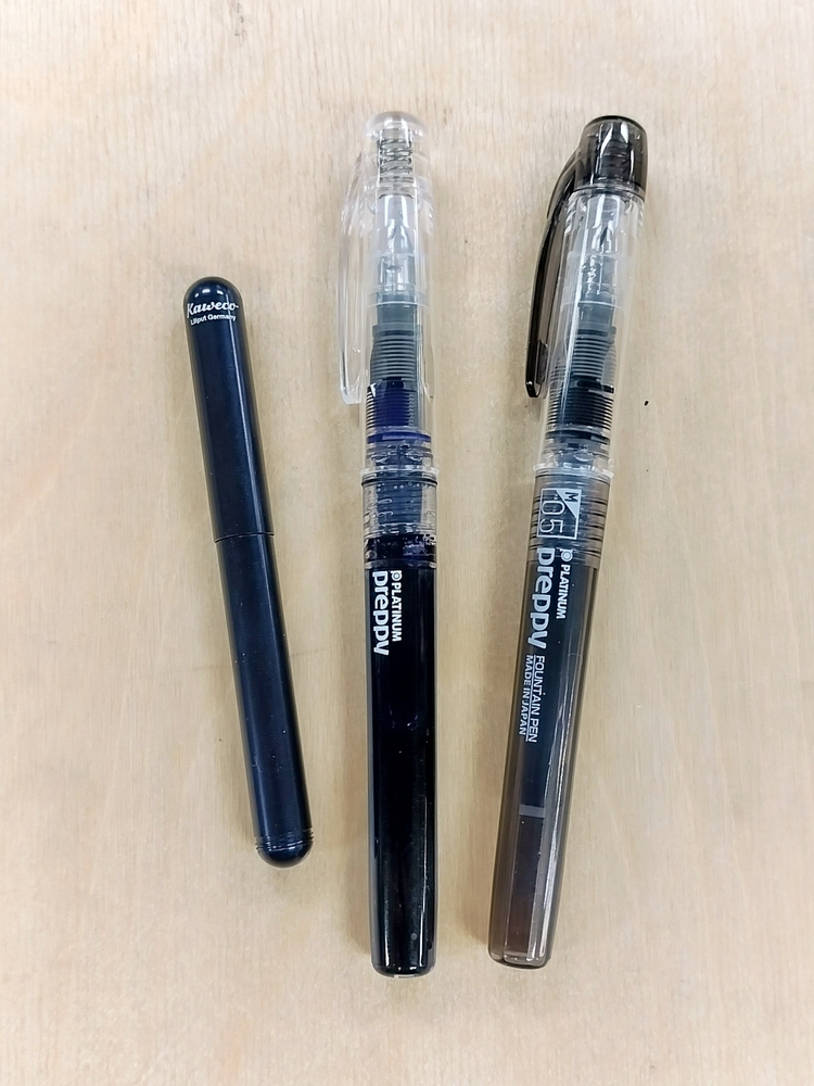 Left-to-right: Kaweco Liliput with broad nib, Platinum Preppy crystal with fine nib and eyedropper conversion, and Platinum Preppy black medium nib.